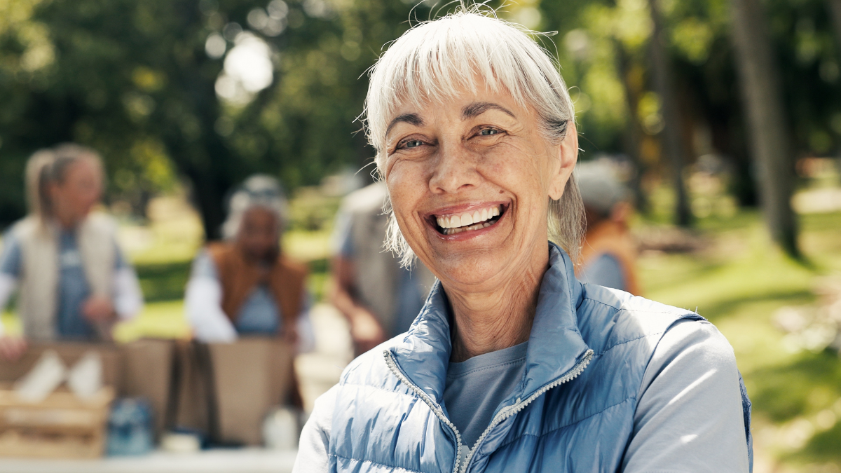 Portrait, volunteer and woman with smile, outdoor and food donations and hope for community outreach. Pride, activist or mature person in park, NGO mission or charity aid for social responsibility 9 Creative Ways You Can Donate to Charity (And Get a Tax Break).
