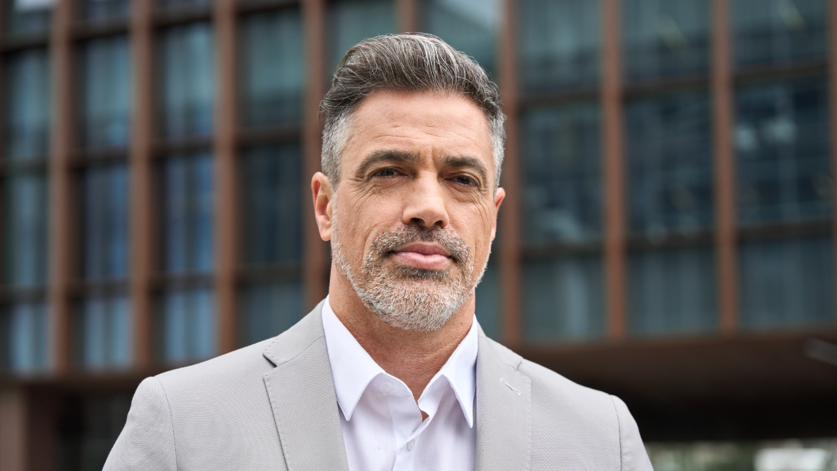 Portrait of confident rich 45 years old middle aged man business owner, mature company ceo executive, Latin investor wearing suit standing outside office on city street looking at camera. Headshot How to Get Rich Quickly,