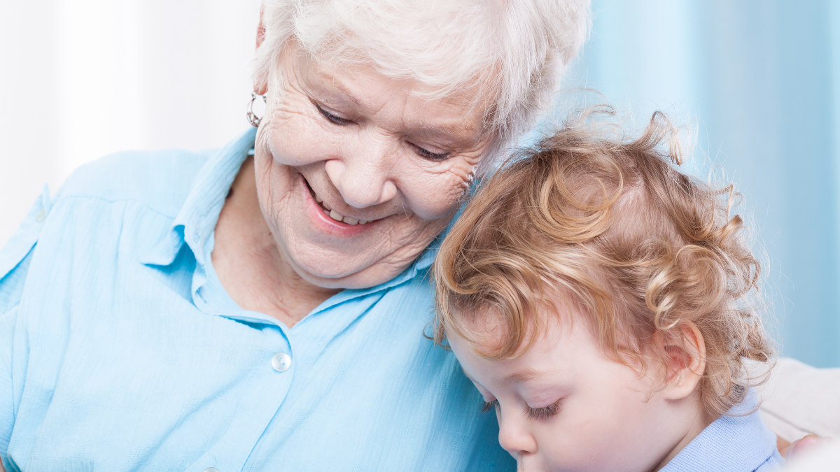 Toddler spending free time with grandma, horizontal making a will.