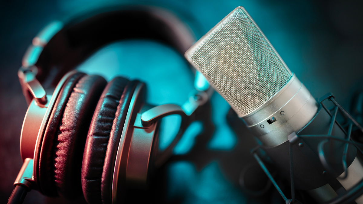 Microphone and headphones close up in recording studio background concept for podcast, music or presentation.