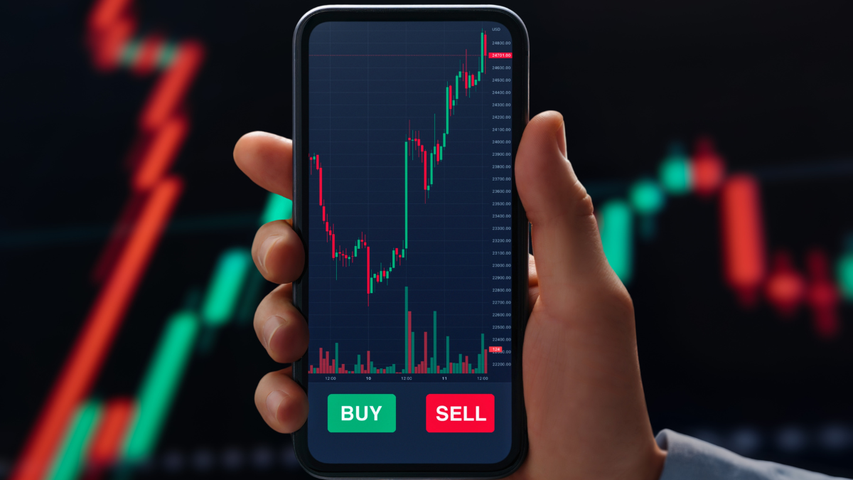 Close up of businessman hand holds phone displaying trading application with real-time forex and cryptocurrency charts, tracking rate fluctuation and market data. What Is the Average Stock Market Return.