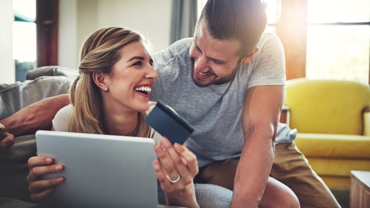 Laughing, tablet or happy couple with credit card in home for ecommerce sale, fintech web or order choice. Funny joke, easy payment or people with financial app, online shopping or internet banking How Many Credit Cards Should I Have.