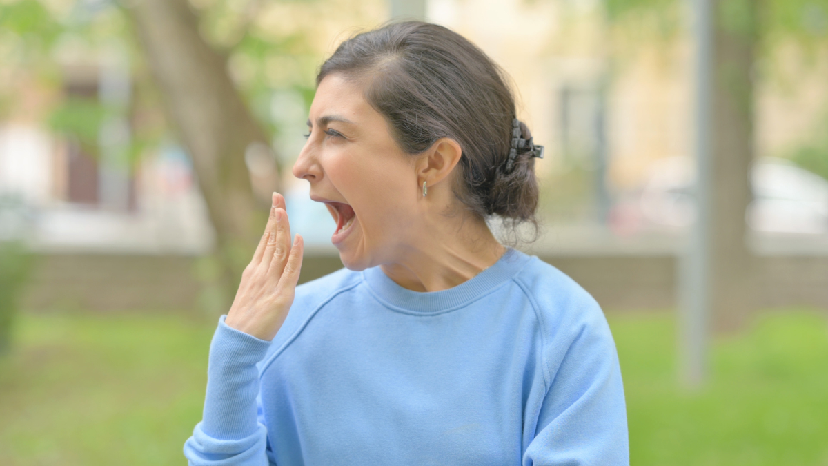 Outdoor Portrait of Yawning Young Indian Woman Need Rest how to fall asleep fast.
