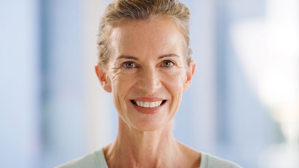 Smile, portrait and calm with woman in home for pride, confidence and weekend break. Happiness, peace and positive attitude with mature female person in living room of apartment for space and rest.