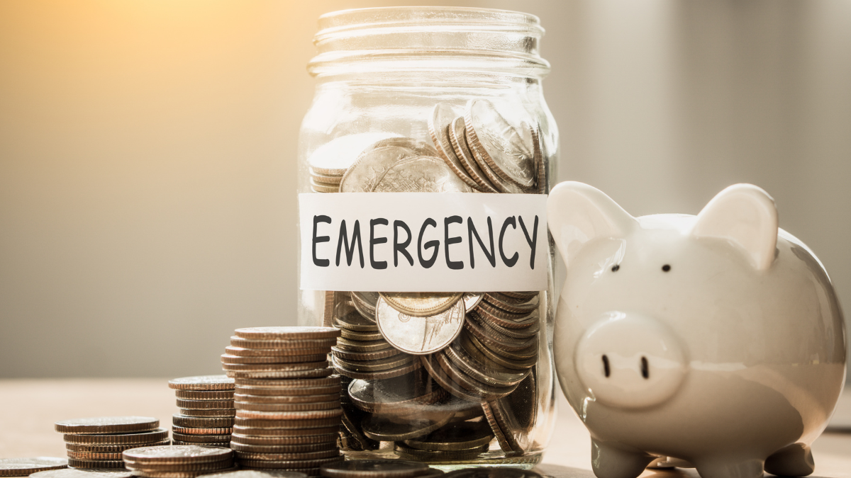 A lot coins in glass money with piggy bank for saving emergency money. Saving for emergency concept.