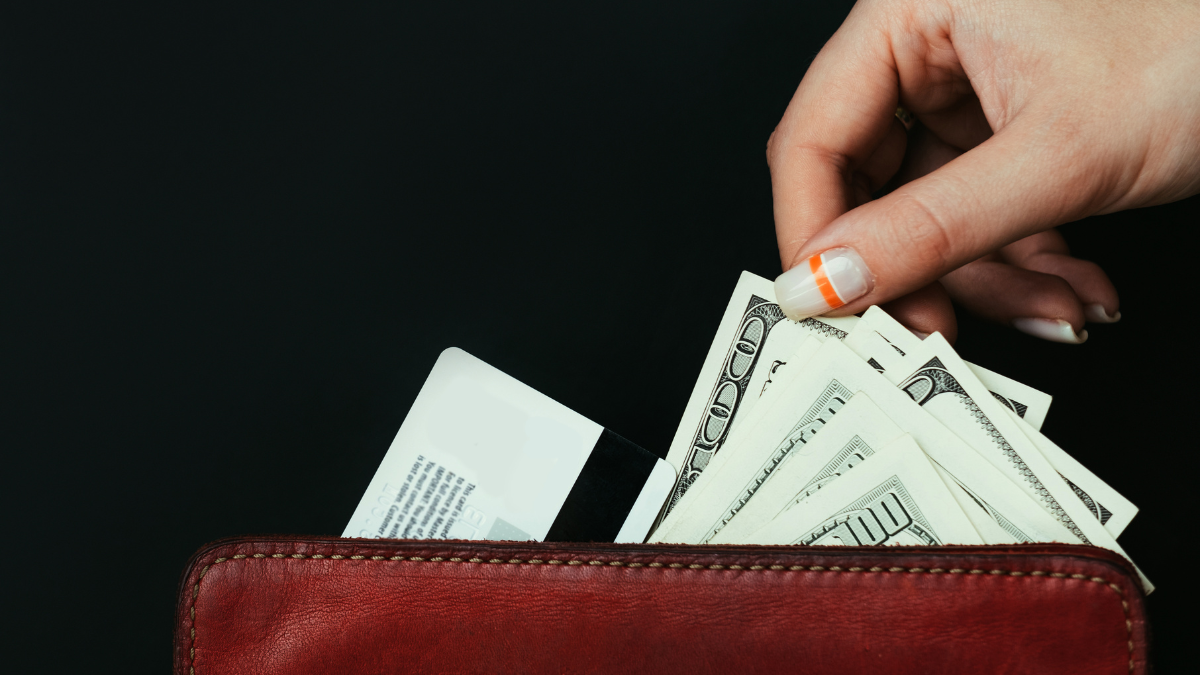 money loan. borrowing from bank or creditors. quick financial transfers on credit card. woman taking out cash from the wallet quick cash ideas.