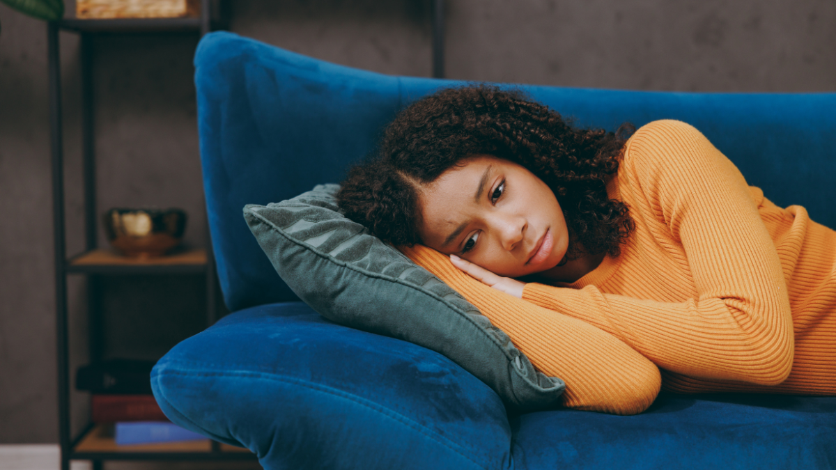 Little depressed frustrated sad kid teen girl she wear casual clothes missing somebody lay down on blue sofa couch stay at home hotel flat spend free spare time in living room indoor. Straightforward Ways To Get Out of Debt.