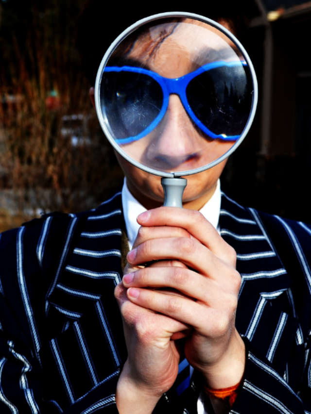 worker looking through magnifying glass
