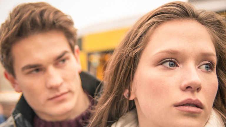 young woman and man looking away