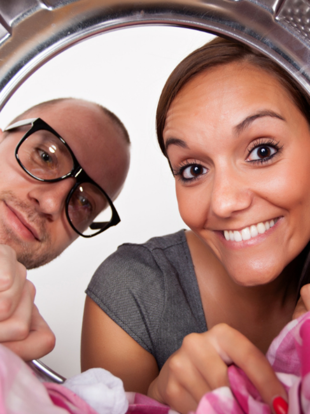 Young couple doing laundry View from the inside of washing machine