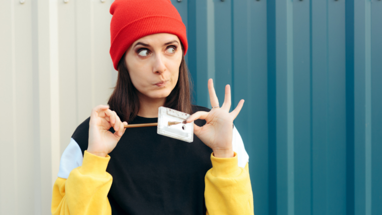 Millennial Hipster Girl Holding an Audio Tape Cassette and a Pencil