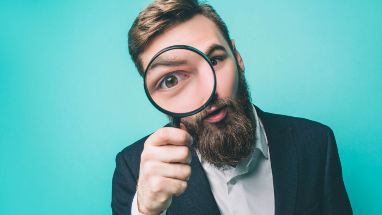 Strange man is looking straight through the loupe