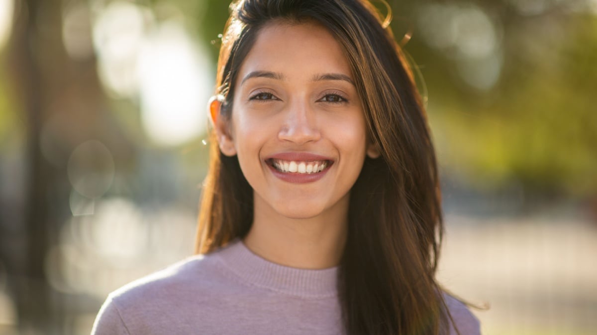 Close up portrait smiling young woman outdoors.