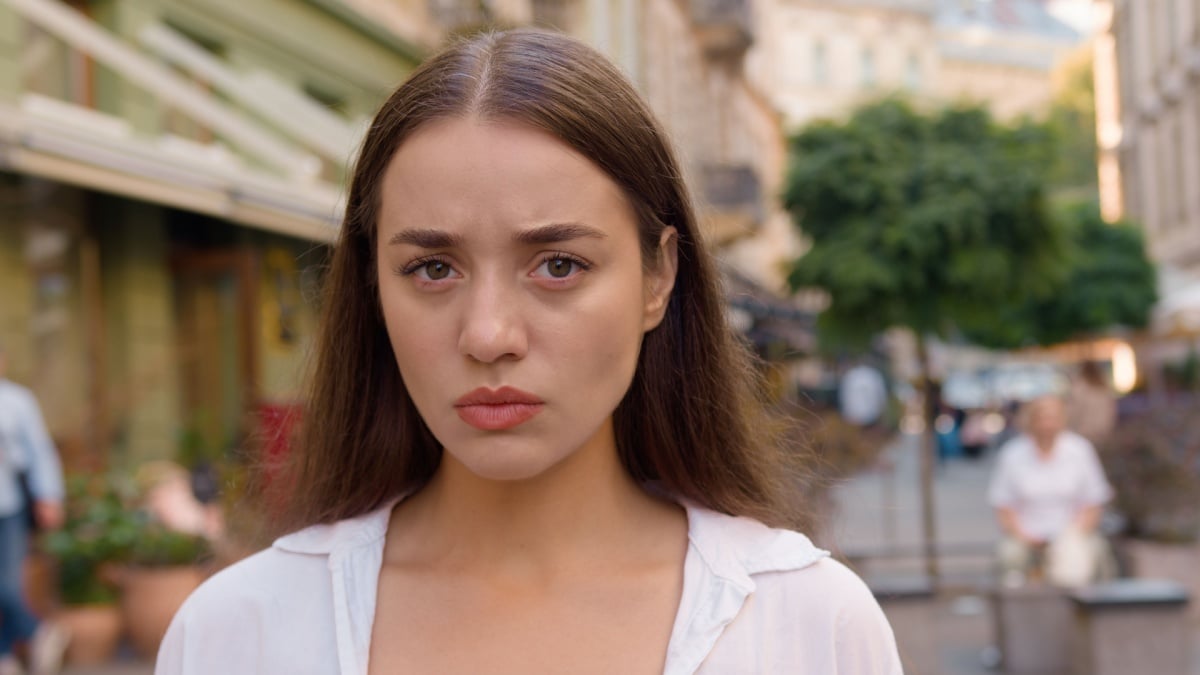 Close up Caucasian unhappy girl street city annoyed woman frowning emotions displeased disappointed dissatisfied angry female envy irritation bad reaction serious expression confident negative pensive.