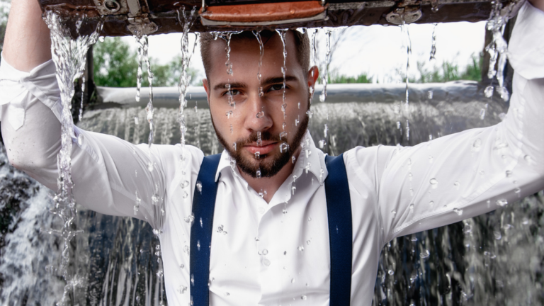 Bearded man concentrated with suitcase in water