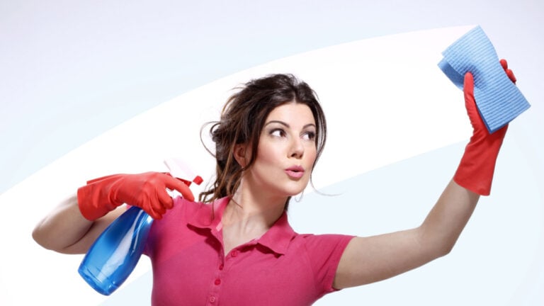 young housewife cleaning on white.