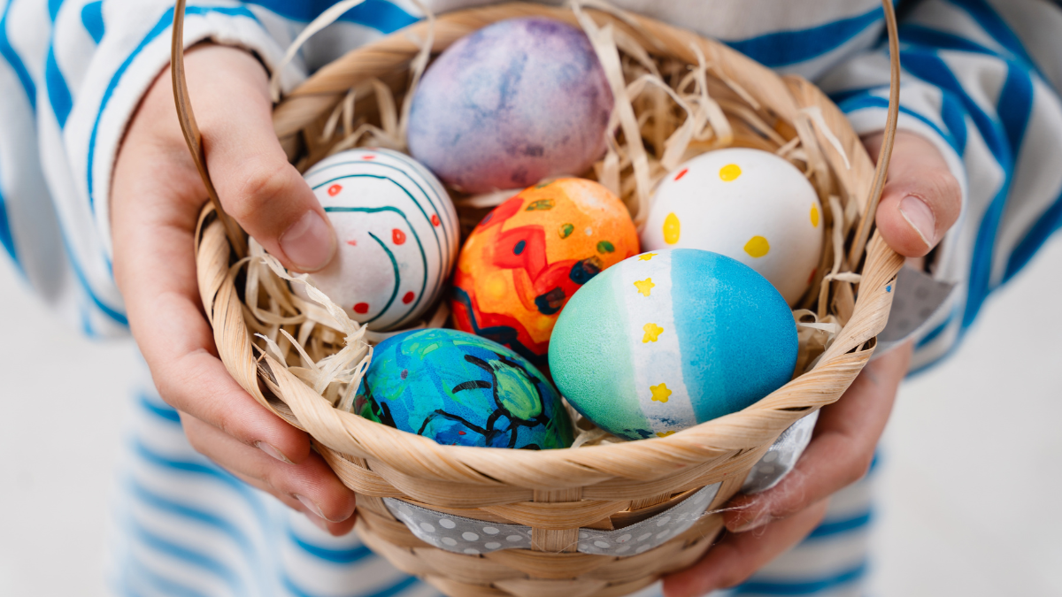 Colorful Easter eggs in basket. Children gathering painted decoration eggs in spring park. Kids hunt for egg outdoors. Festive family traditional play game on Easter easter games for the whole family.