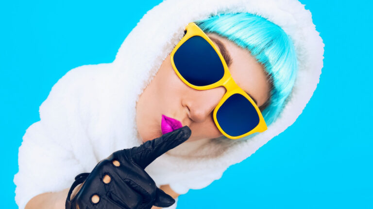 Guess Fashion Girl in a white Hoodie on a blue background. Winter Hipster Style.