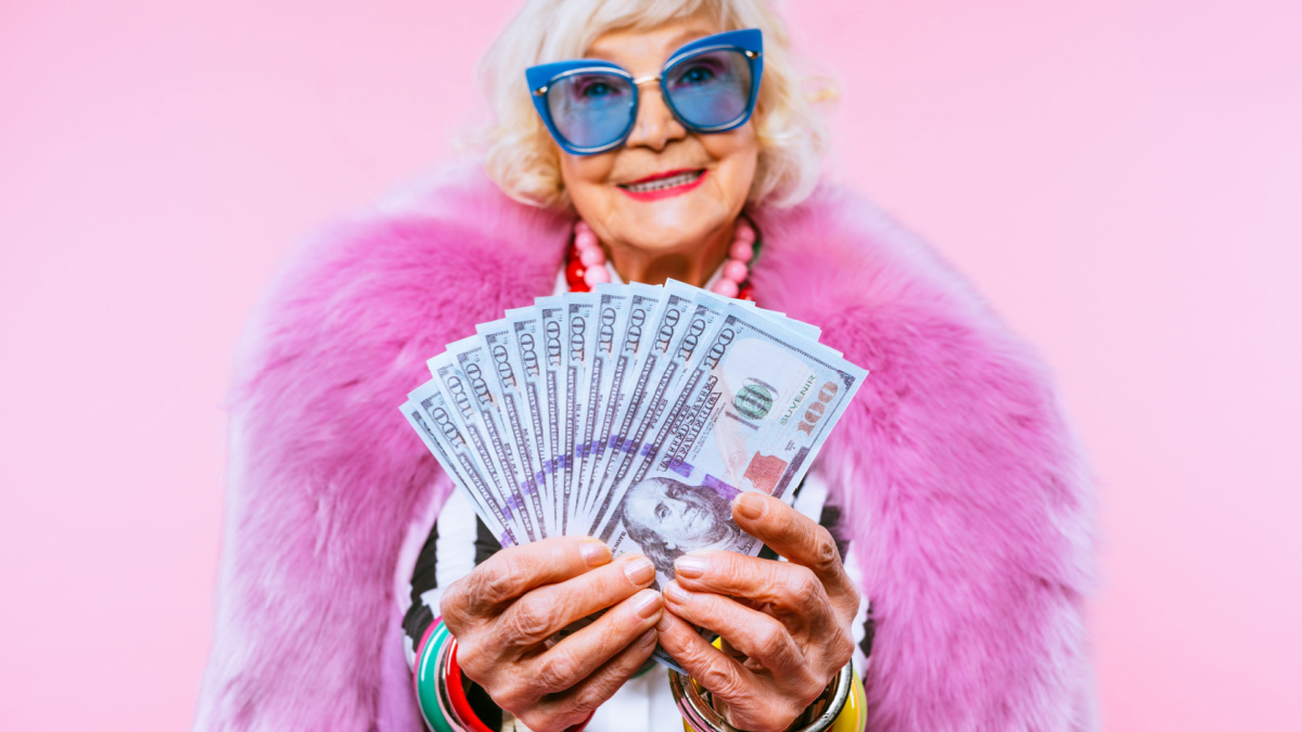 Happy and funny cool old lady with fashionable clothes portrait on colored background.