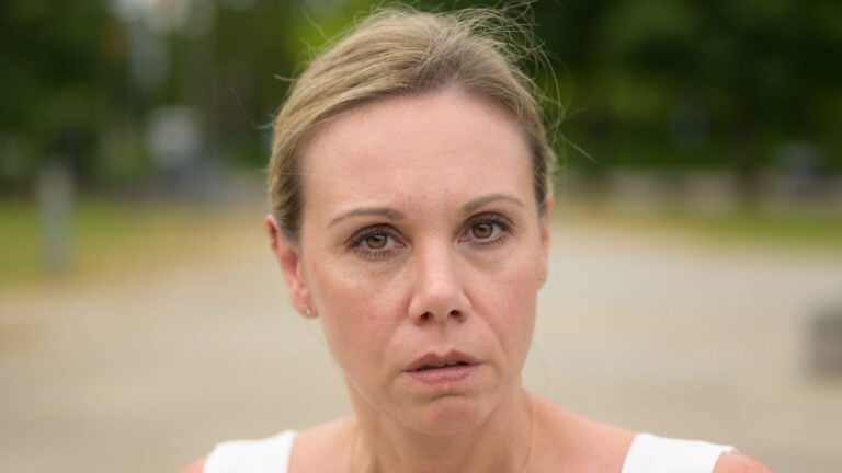 Close-up of an attractive forty year old woman looking annoyed at the camera.