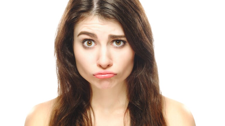 Disappointed funny cute girl woman face isolated on white background..