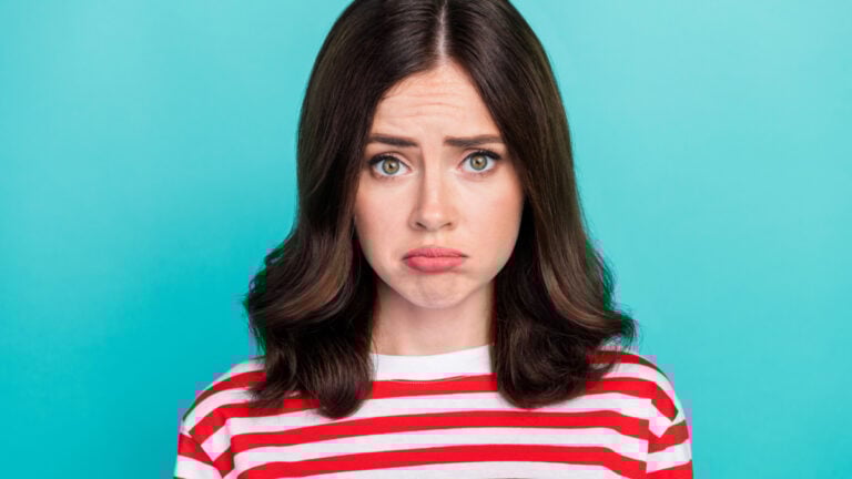 Closeup photo of young attractive gorgeous nice woman wear striped t-shirt pouted lips unhappy sad face cry problem offended isolated on cyan color background.