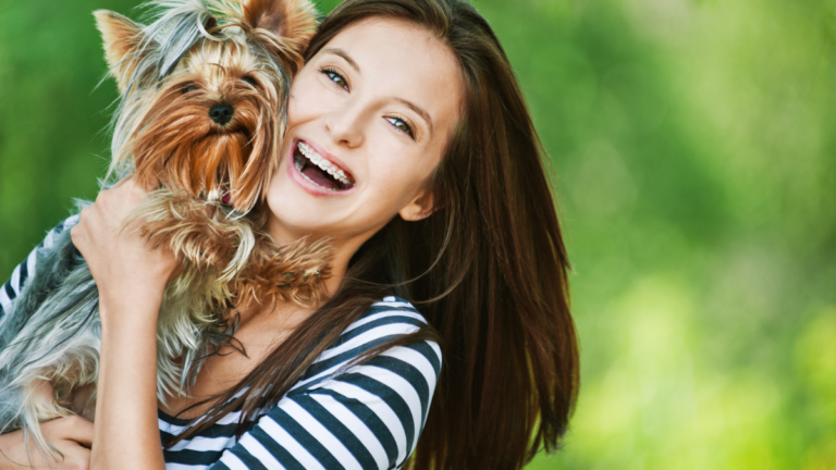 Woman beautiful young holds small dog.