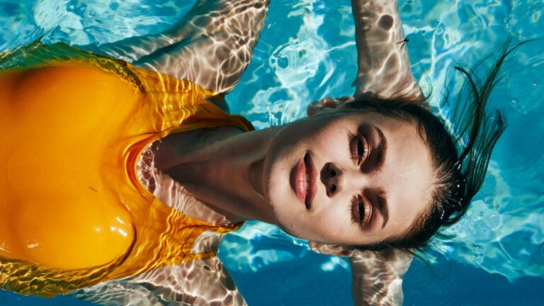 pretty woman in a yellow bathing suit lying near the pool of health luxury nature tropics model.