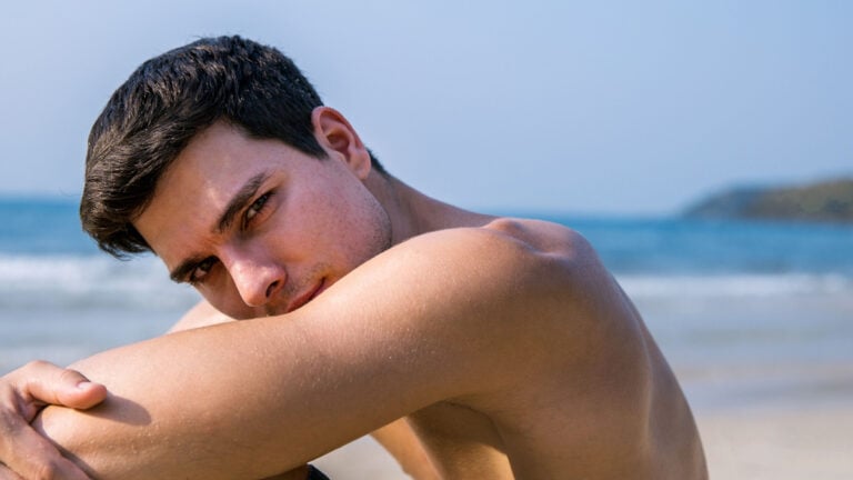Portrait of handsome sexy caucasian man on the beach..