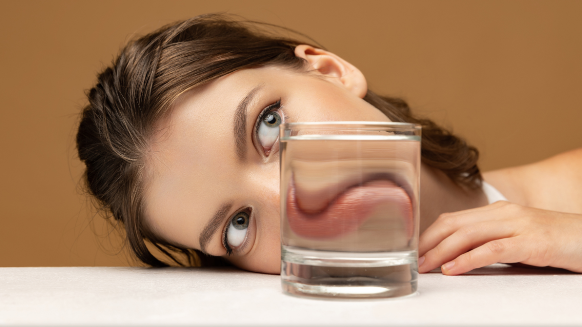Apathy. Weird emotions, facial expression concept. Modern art photography. Beautiful girl's face through glass of water. Object distortion, optical illusion. Minimalistic contemporary art. Poster. weirdest money-saving tips SH