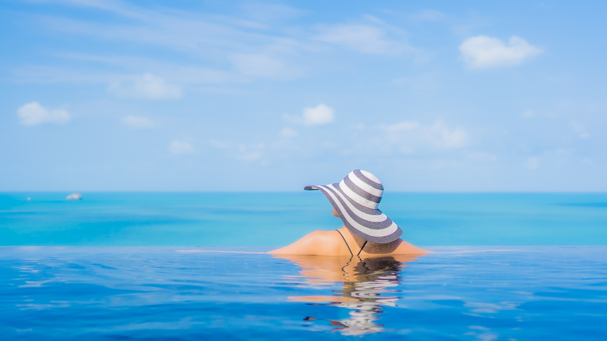 Portrait beautiful young asian woman relax smile leisure around outdoor swimming pool in resort hotel with sea ocean view living your best life. live your best life.