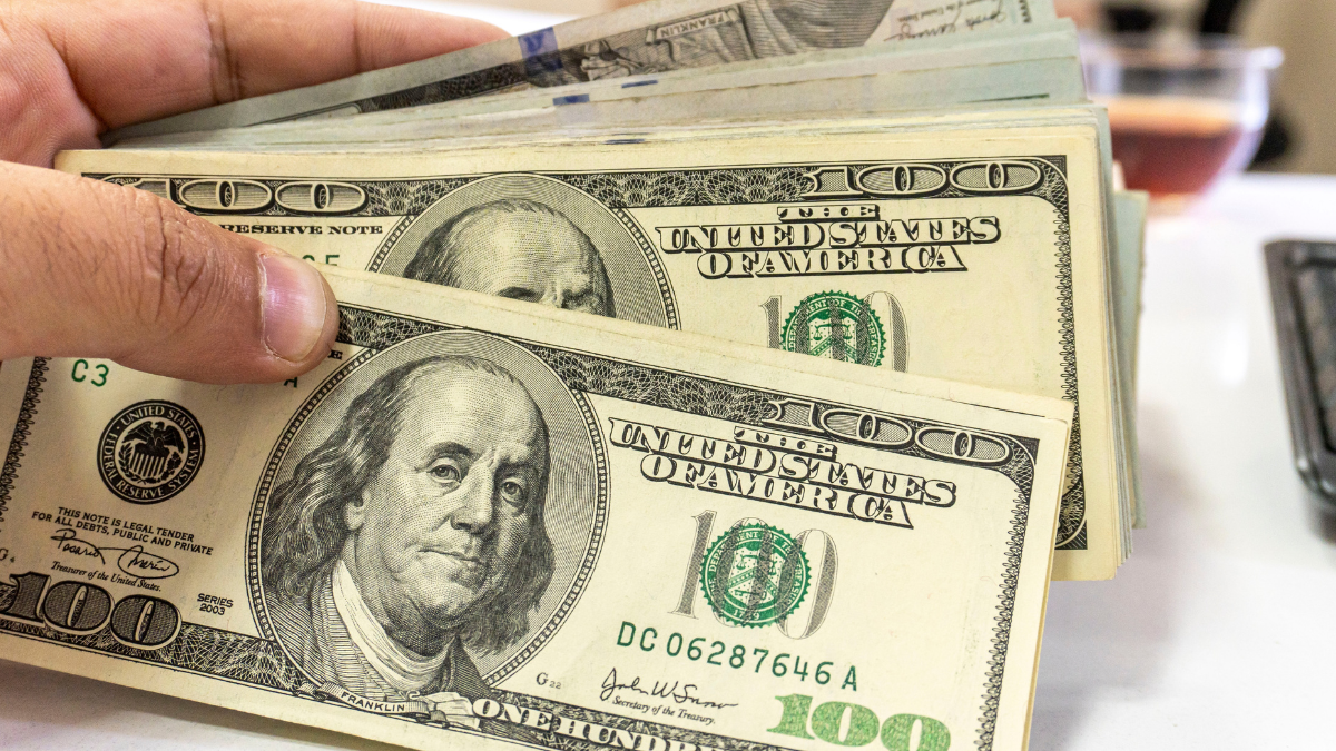 Close up view of cash money, 100 one hundred US dollar bills, 50 US dollar bills, 20 US dollar bills, lots of cash. cash stuffing.