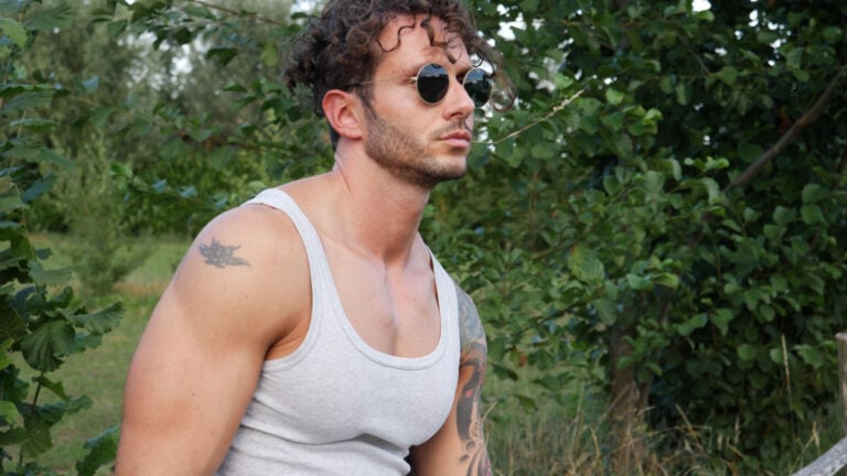 Handsome Muscular Hunk Man Outdoor in Countryside Standing on Grass.