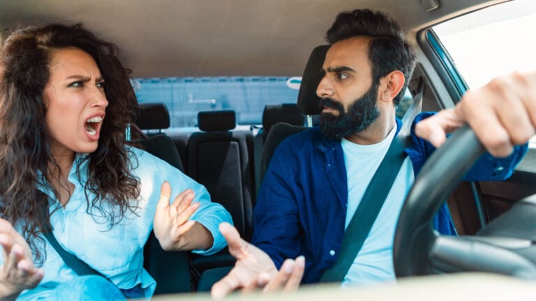 Family quarrel In auto. Angry arab couple arguing and shouting at each other in car while driving in automobile. Emotional middle eastern spouses having conflict.
