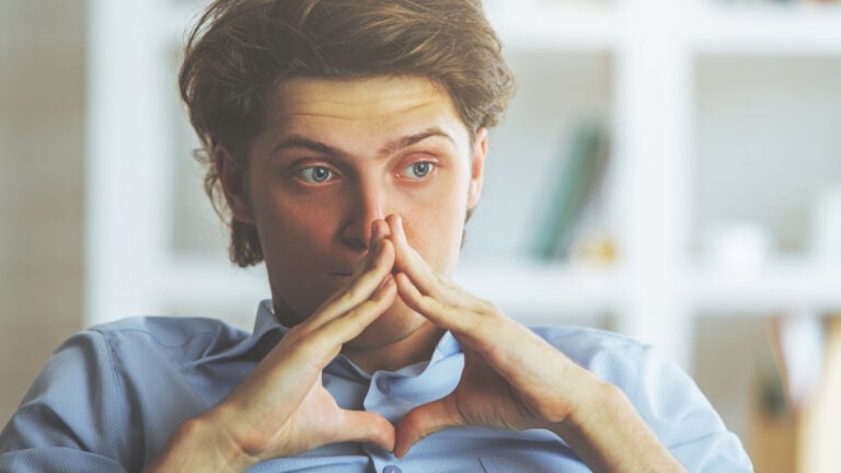 Portrait of worried young man at workplace. Stress concept.