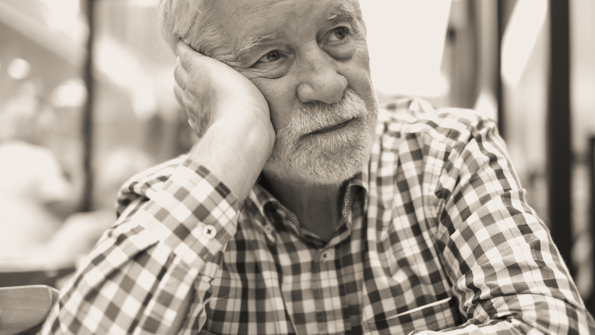 Black and white portrait of sad man - handsome bearded elderly man sitting thoughtfully holding his face in the hand, concept of unhappiness, stress depression people. These 20 Things Have Gone From Everyday Items to Luxury Goods in Just 20 Years.