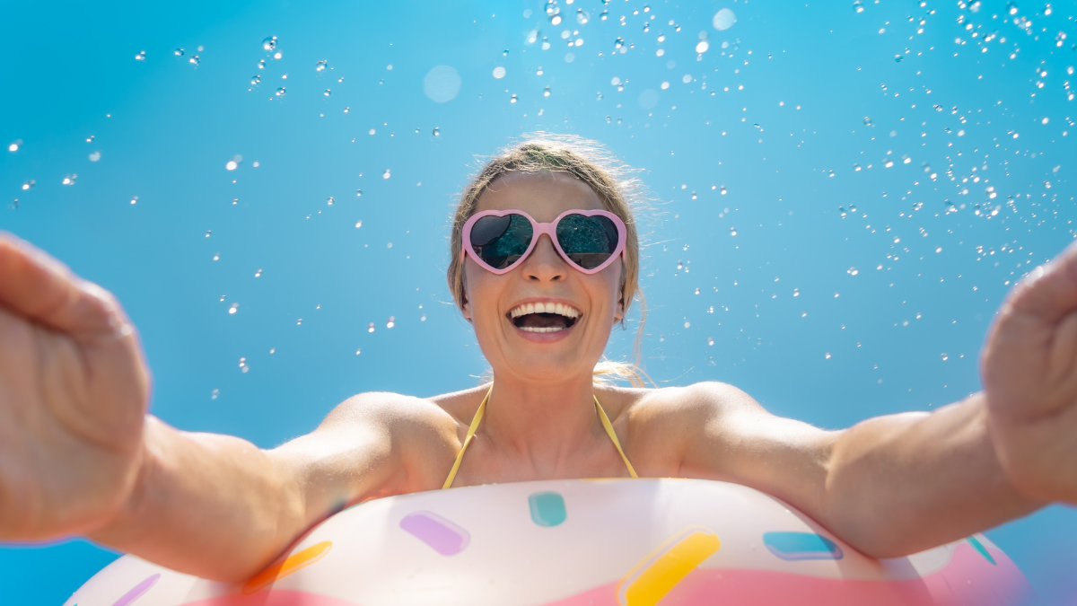 Happy woman having fun on summer vacation outdoor against blue sky background fun things to do outside.
