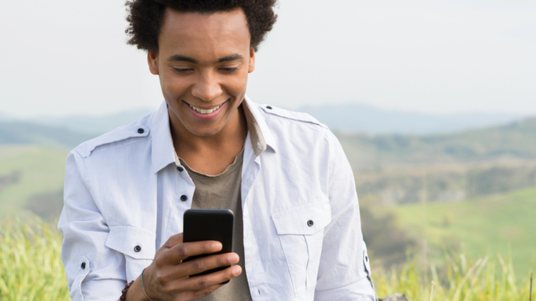 man holding phone looking happy at app.