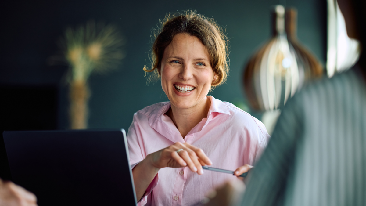 Happy businesswoman working with colleagues in the office.