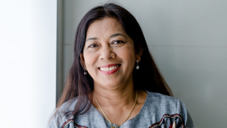 Portrait of asian woman 60s smile looking camera at home.