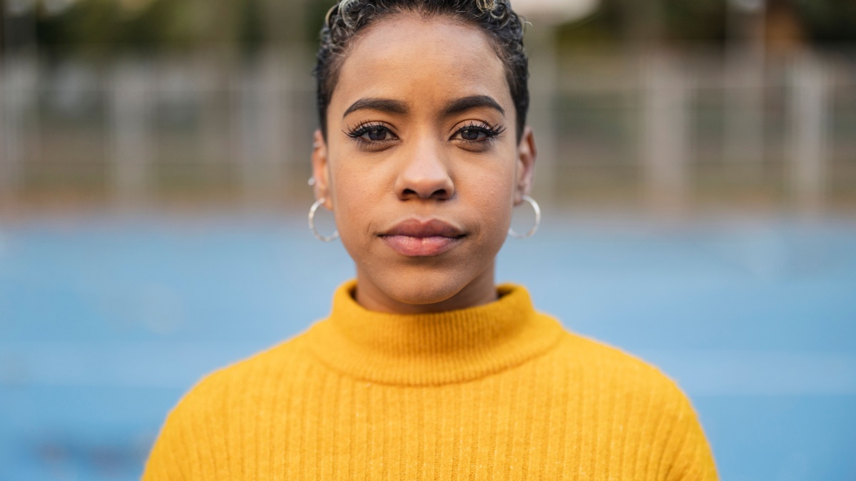 portrait hispanic woman short hair, looking at camera serious.