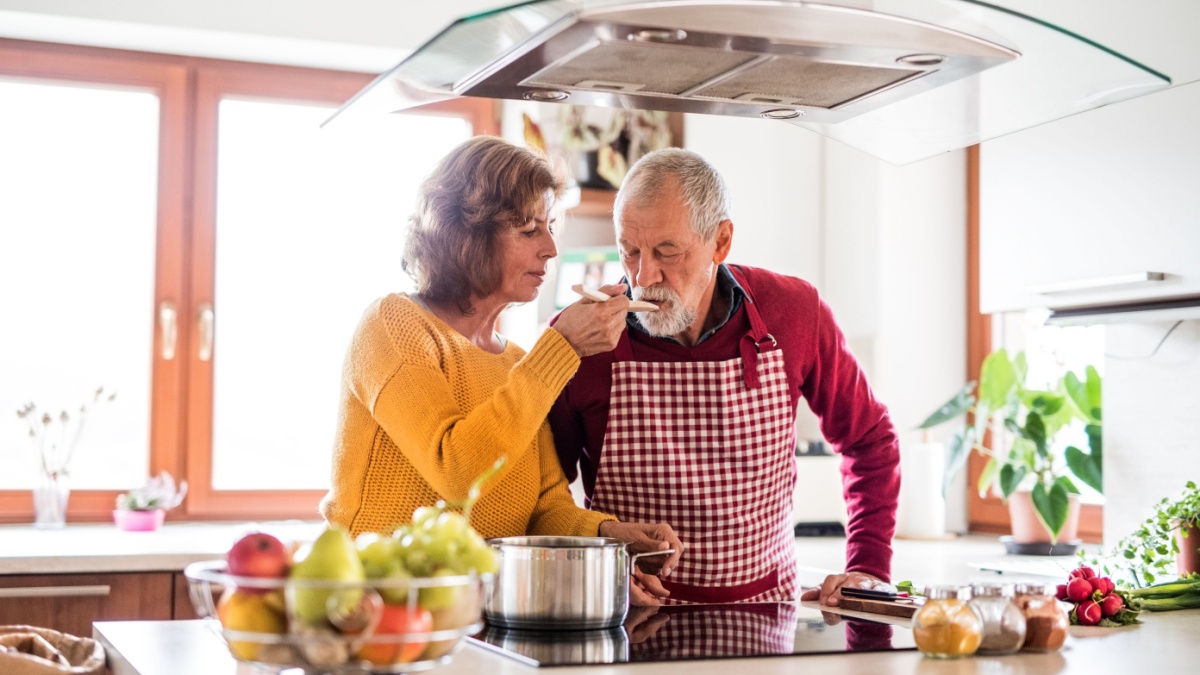 Senior couple preparing food in the kitchen.