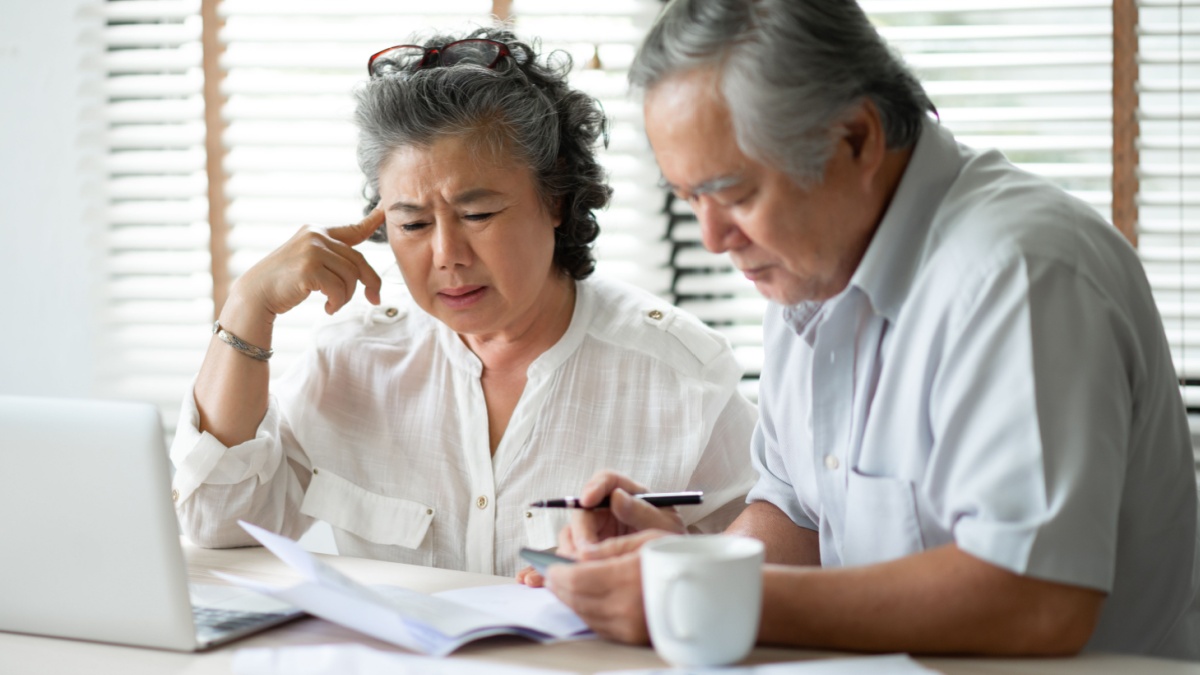 Serious Asian Senior Couple thinking about their Debts with laptop computer. Saving, Financials, monthly expense with Retirement.