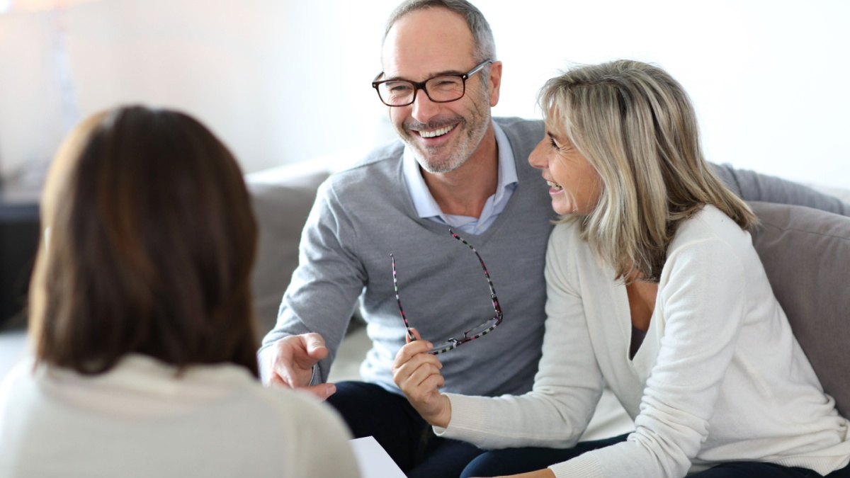 Senior couple meeting financial adviser for investment.