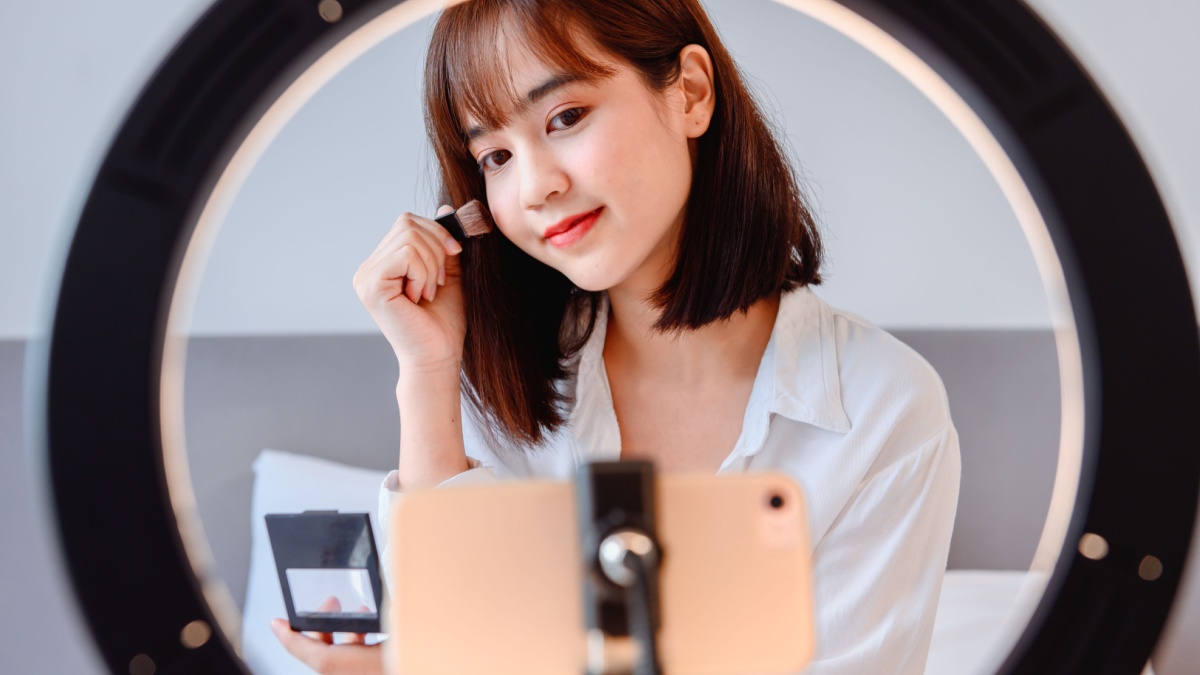 Woman blogging online and streaming live. Asian entrepreneur use social media for business at home. New normal lifestyle and Social Distancing.