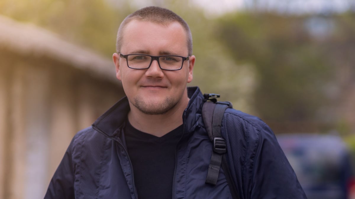 Portrait of a young man on a blurred background with selective focus and copy space for text.