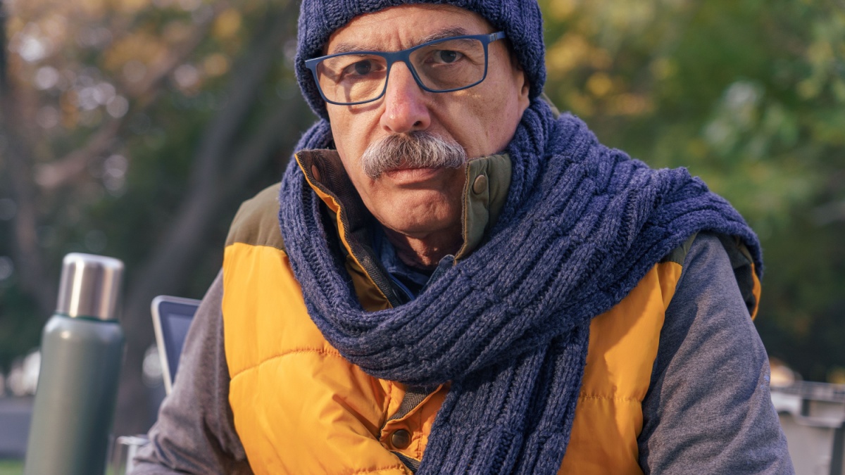 Senior Man Resting on a Table in Autumn Nature.