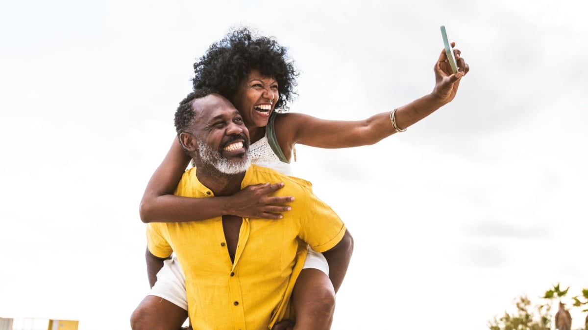 Beautiful mature black couple of lovers dating at the seaside.