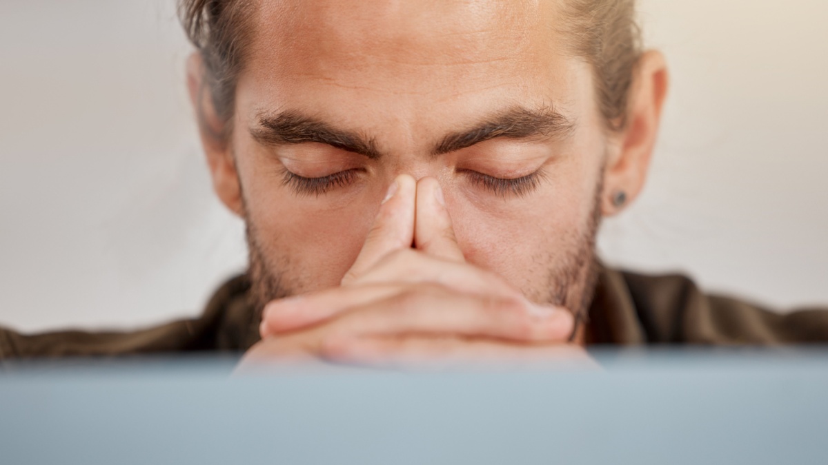 Stress, businessman and headache at desk for company, project and burnout in workplace.