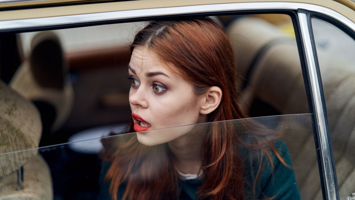 surprised woman in car.